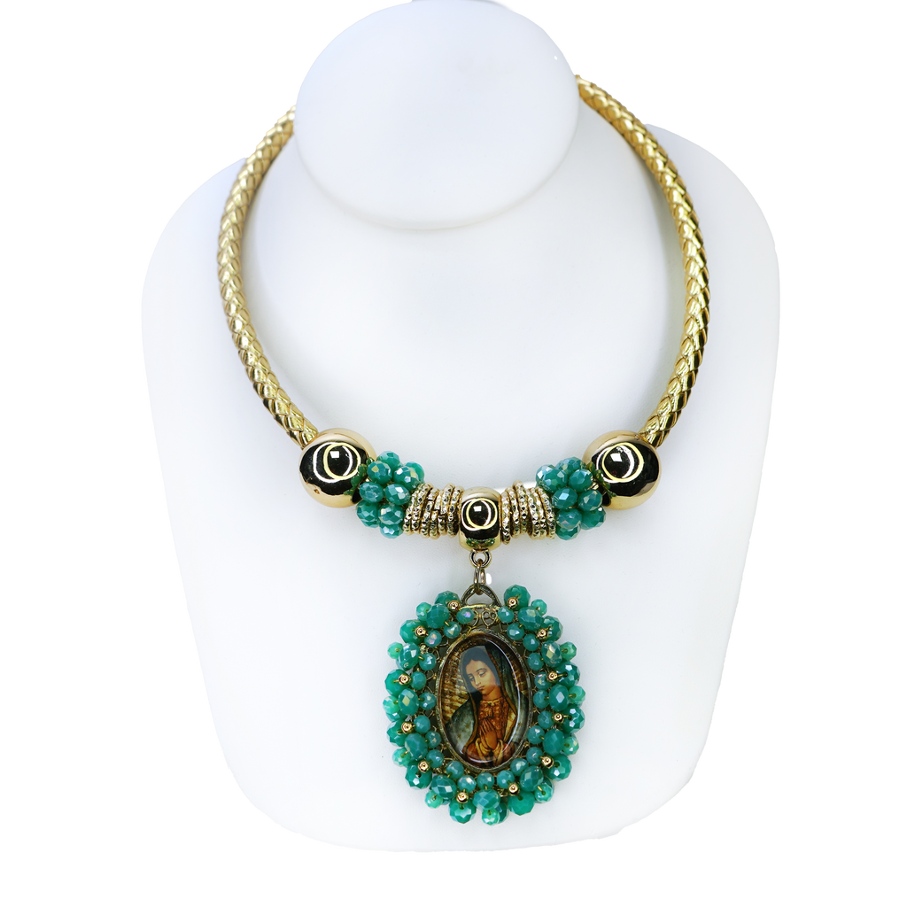 Gold and turquoise beaded necklace with a pendant on a white stand
