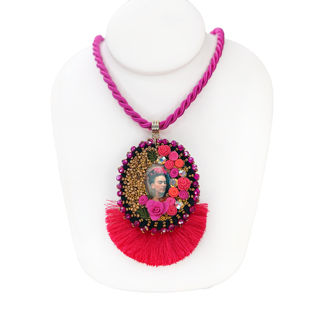 Necklace with floral pendant and pink tassels on a white background